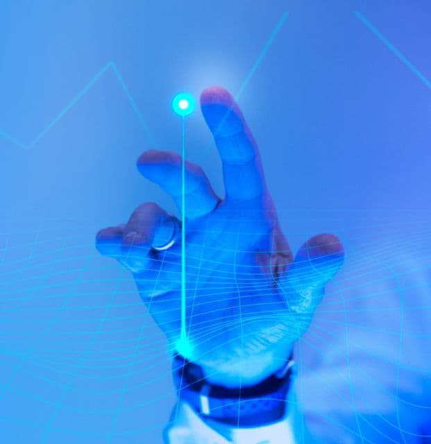 An image showing a person's hand tapping on a blue screen.